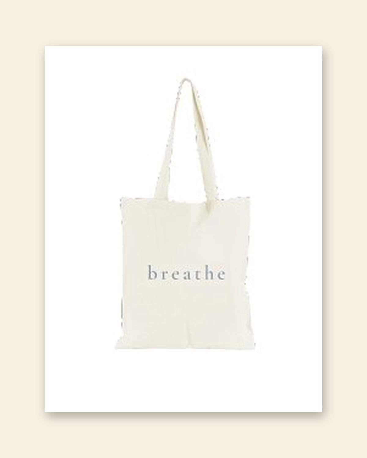 Shop mockup of the front of the Breathe Tote in natural canvas: the single word breathe in dusty-blue serif lettering, on a white card