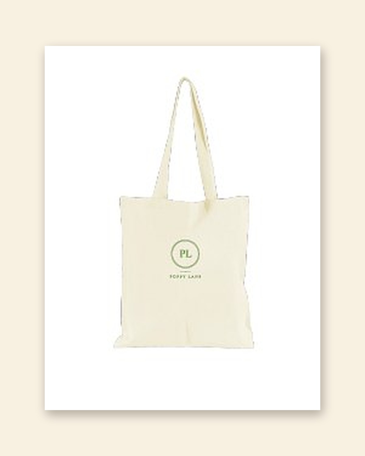 Shop mockup of the Monogram Tote in natural canvas: the PL monogram in a green ring with the words Poppy Lane beneath, on a white card